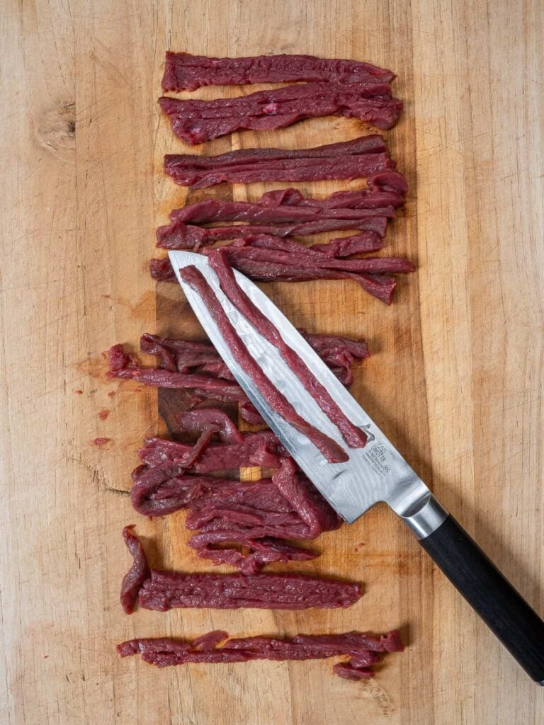 venison steak cut into strips.