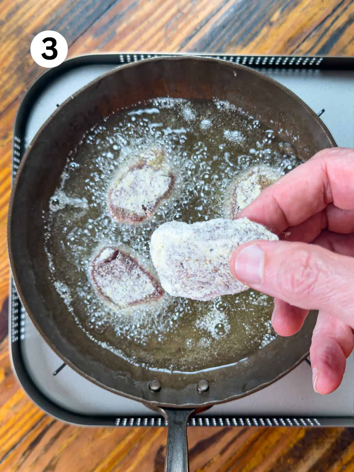 Frying venison backstrap in a cast iron pan.