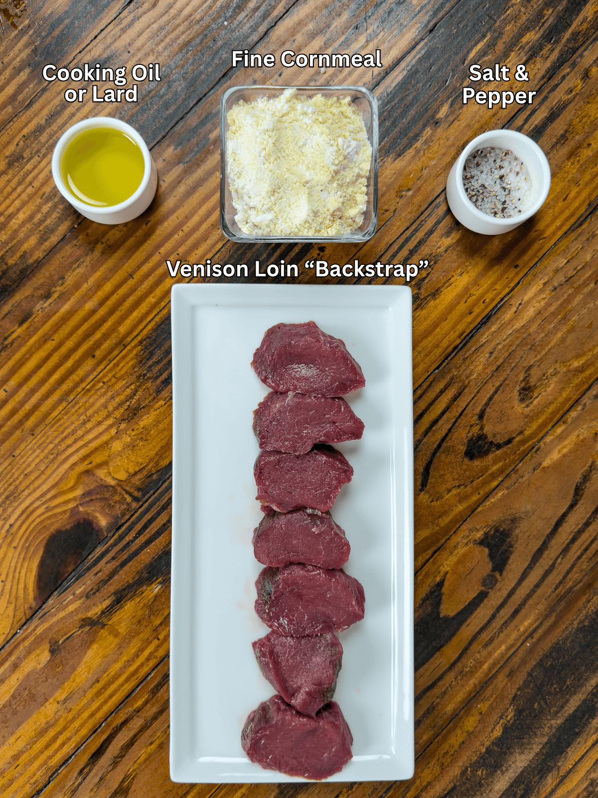 Ingredients for fried venison backstrap on a wooden table.