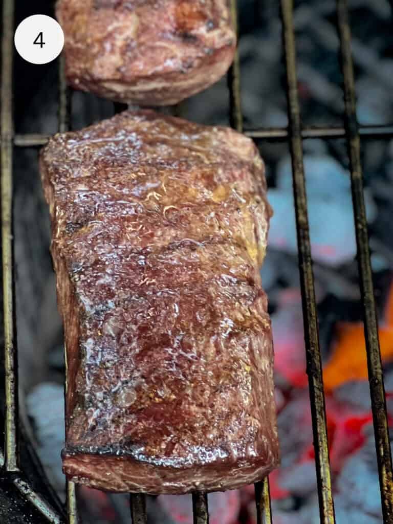 Steaks on a grill.