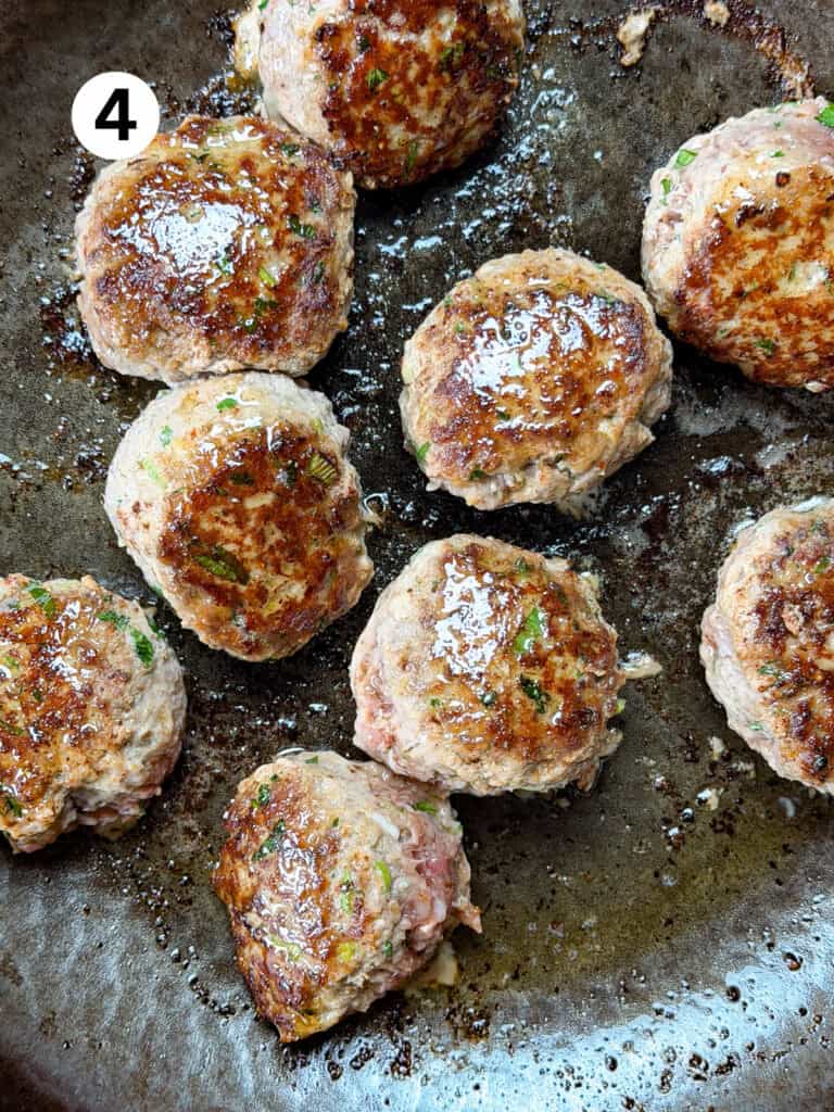 Seared venison meatballs in a carbon steel pan.