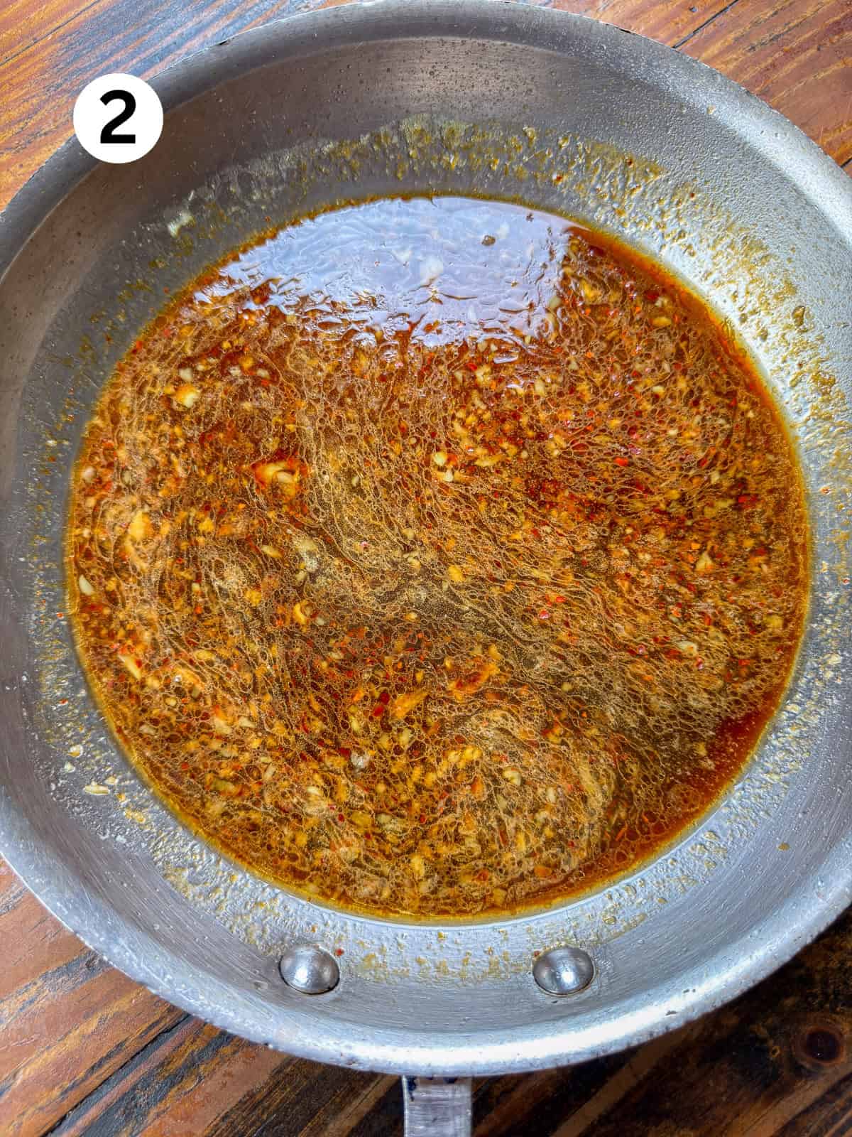 Venison stir fry sauce in a stainless steel pan.