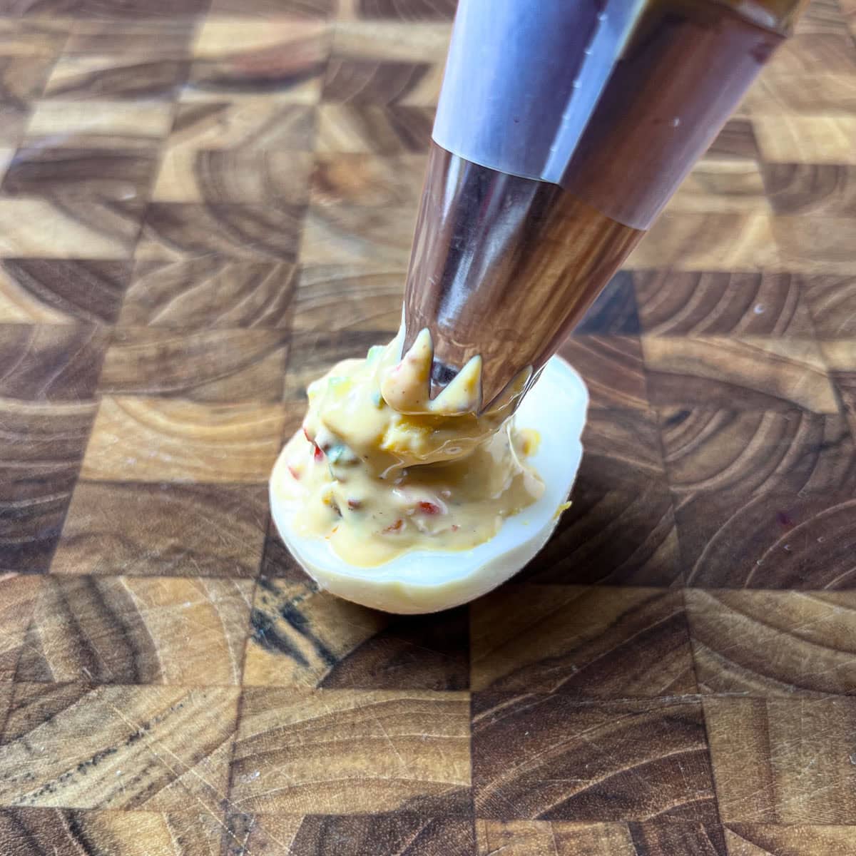 Using a pastry bag to fill deviled eggs.