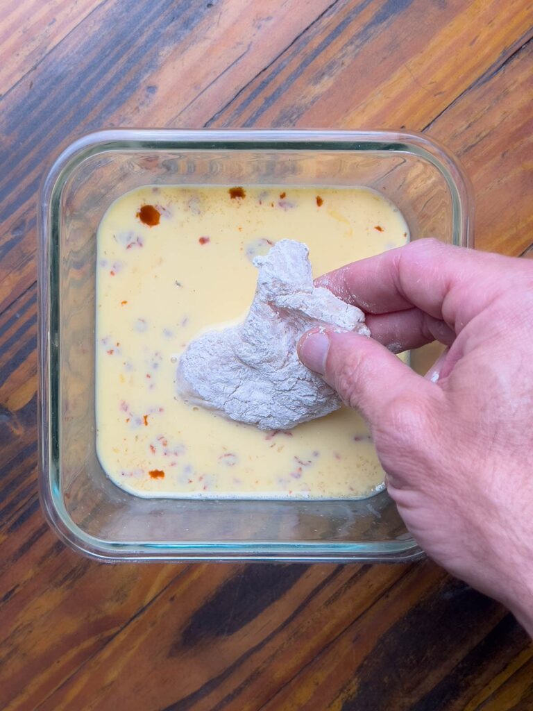 Dipping catfish in eggwash.