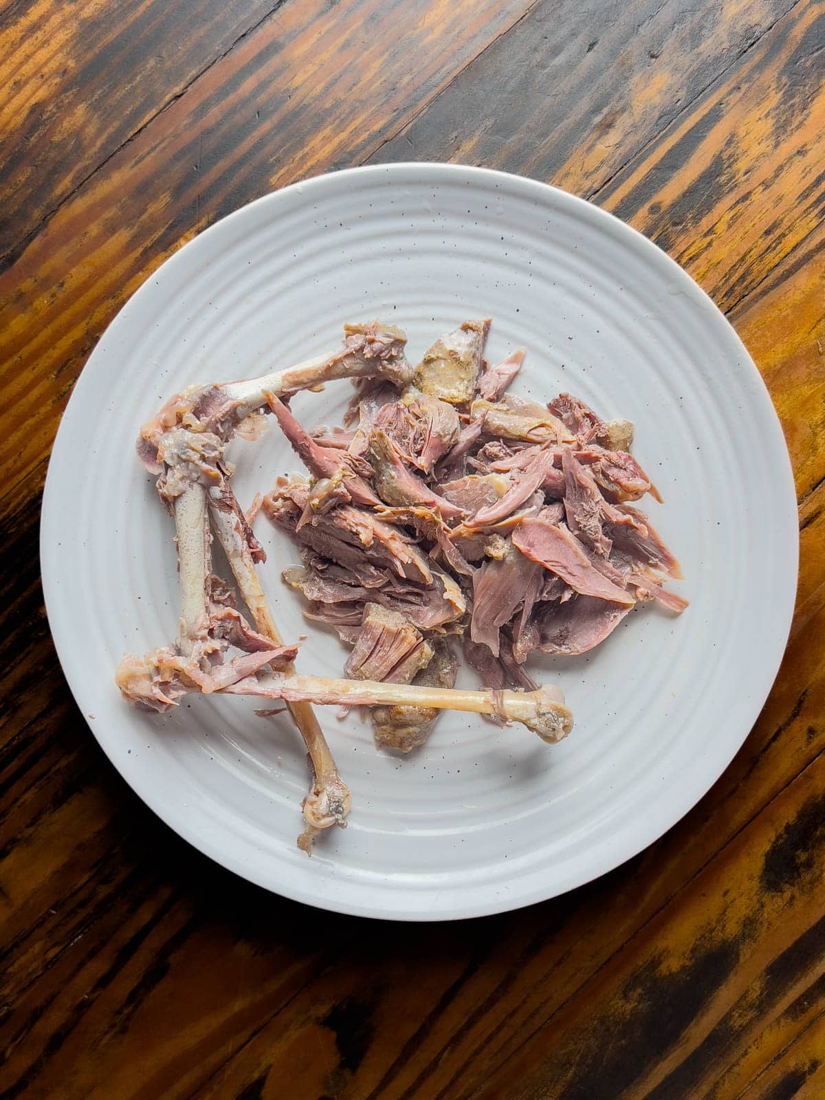 Shredded goose legs on a plate.