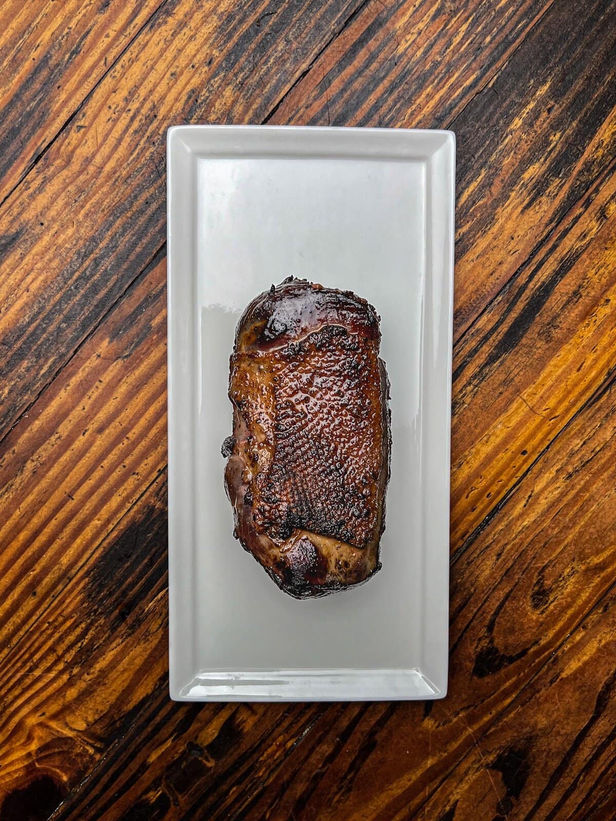 Smoked goose breast on a plate.
