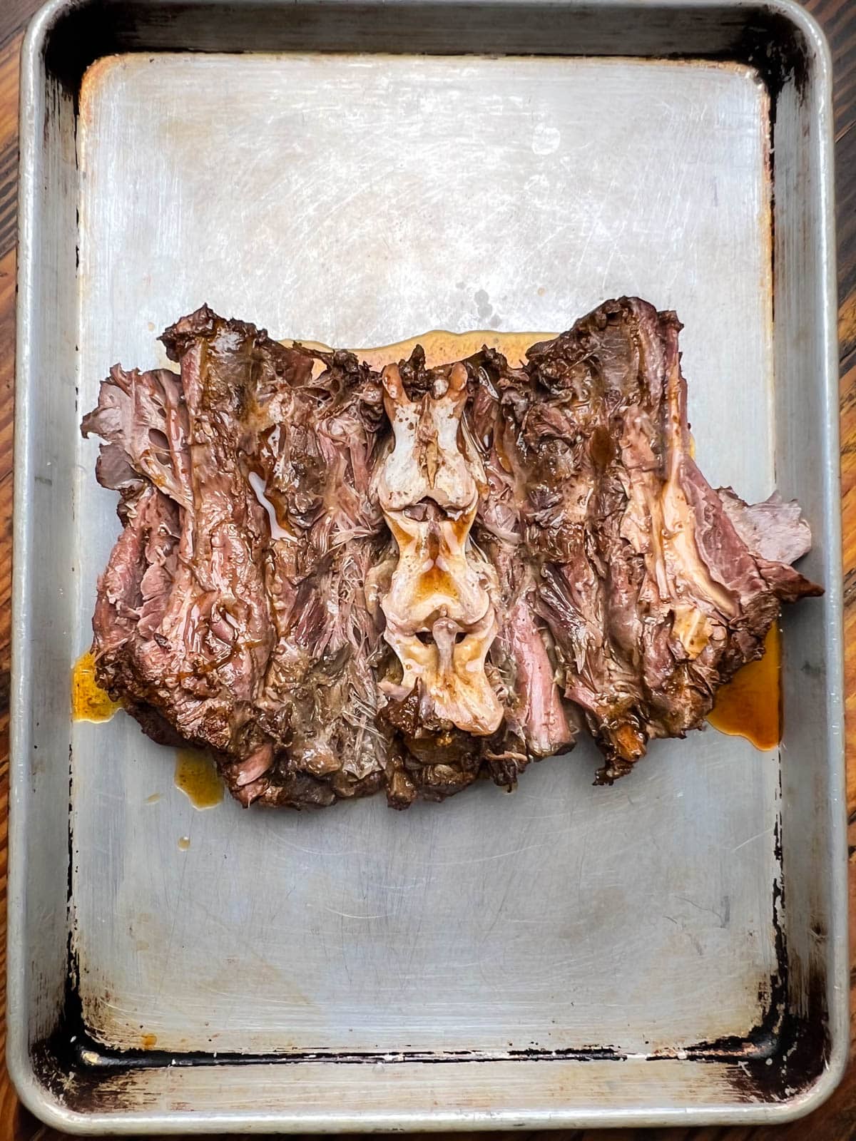 Cooked deer neck roast, exposing the spine.