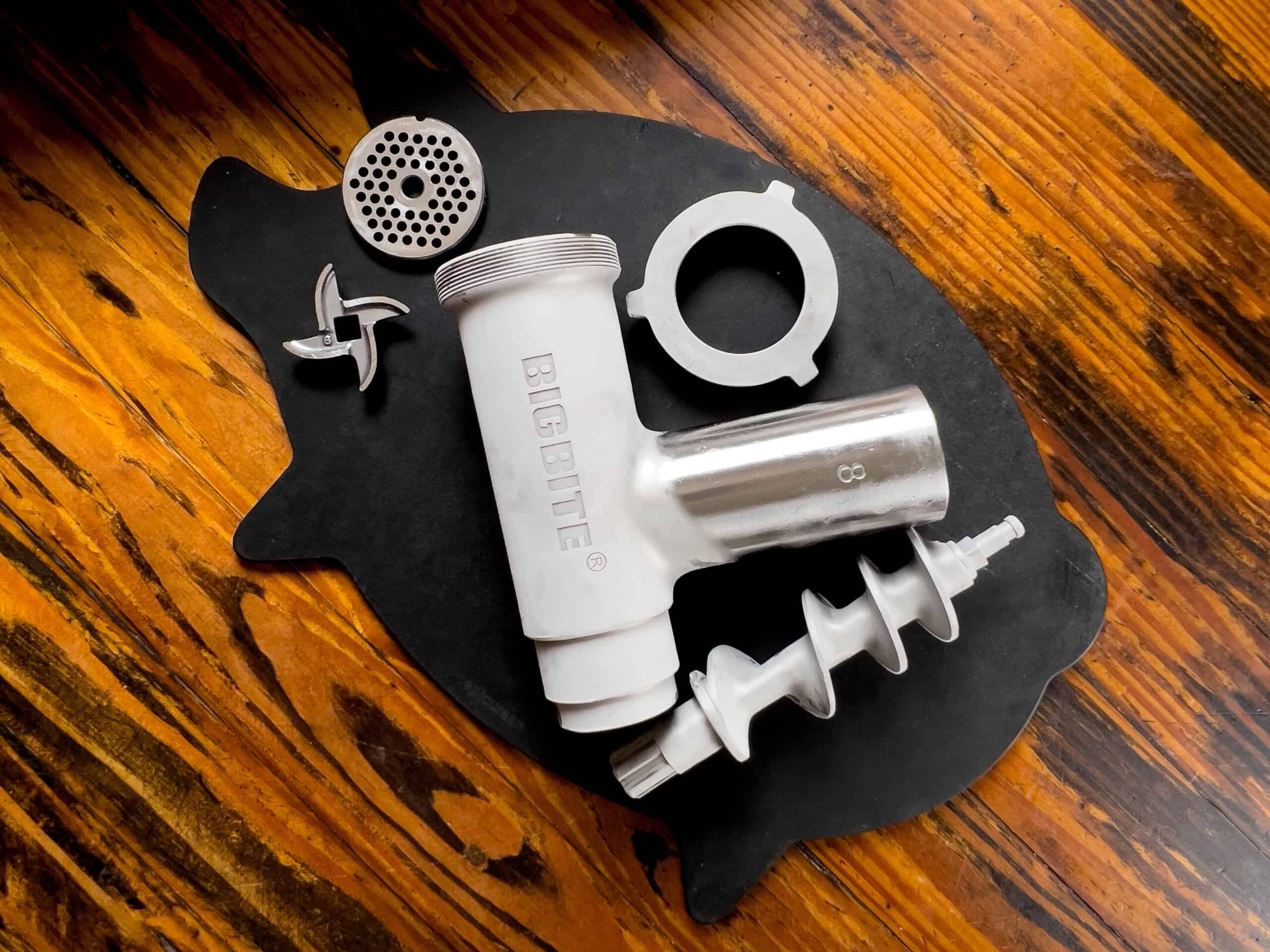 Chilled grinder parts resting on a cutting board.