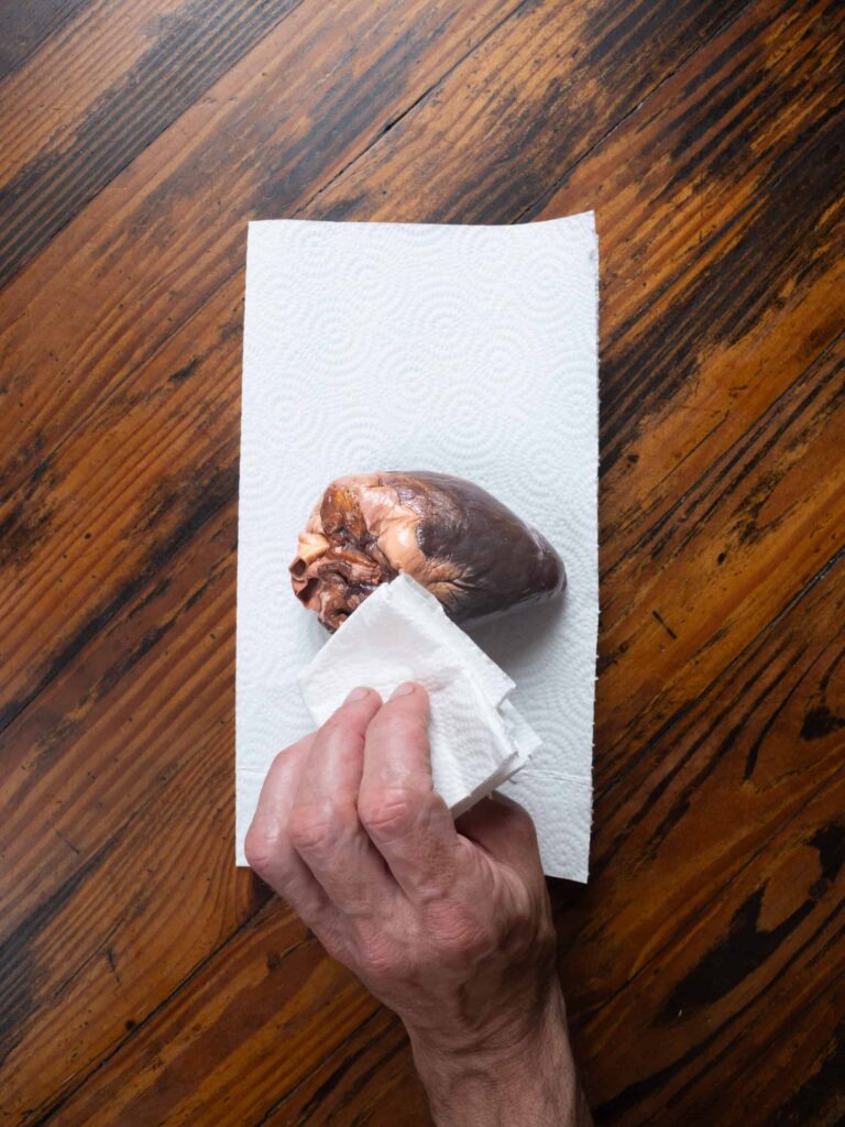 drying deer heart with paper towel.