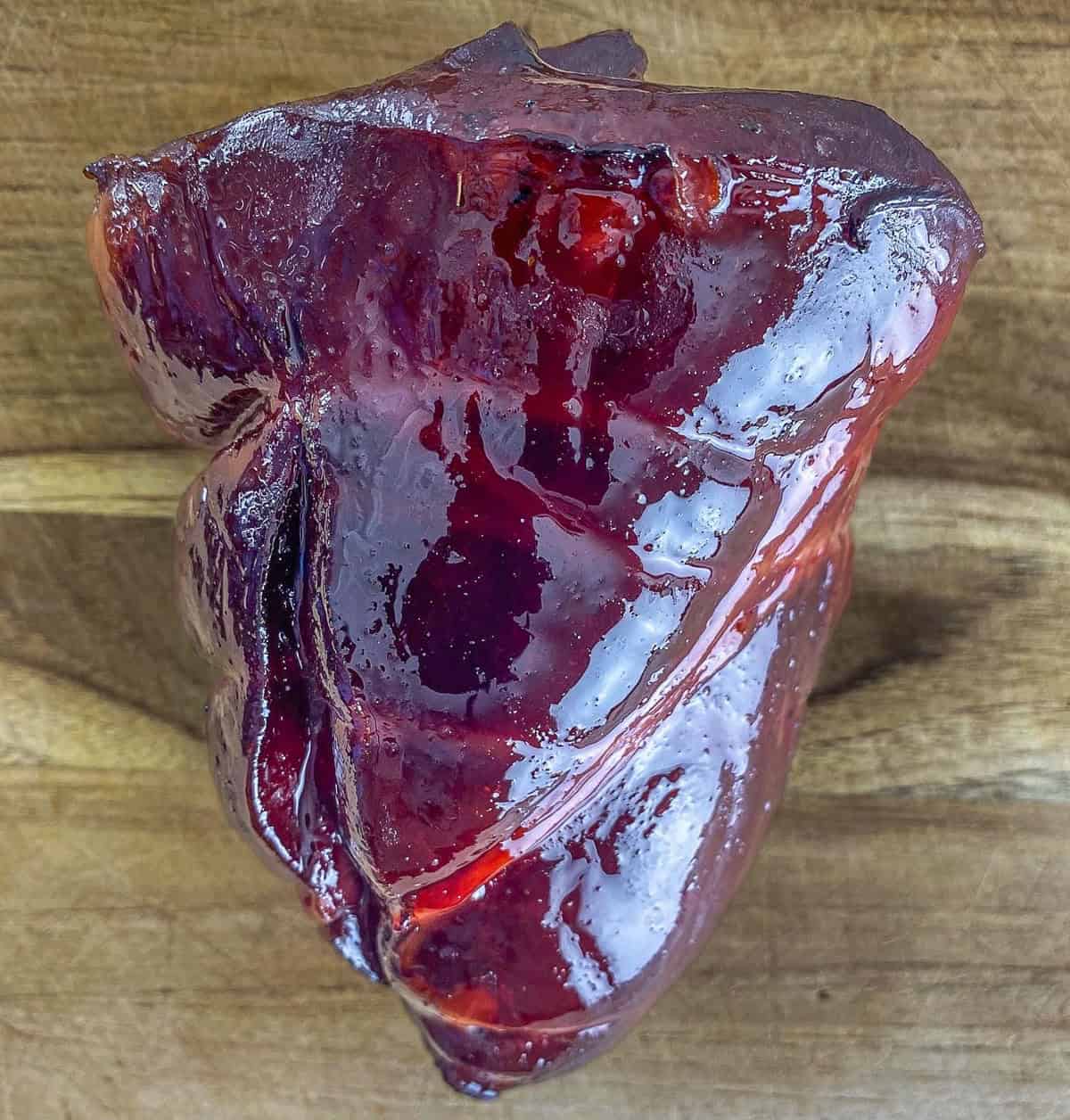 Smoked deer heart on a cutting board.
