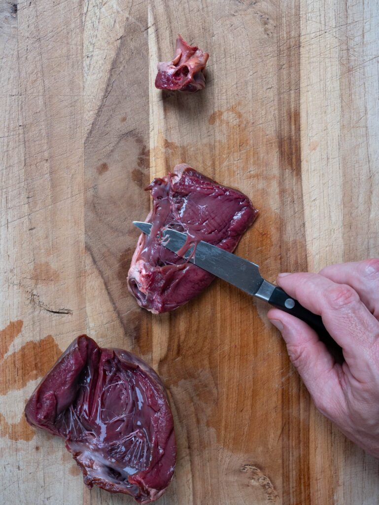 trimming the connective tissue of from a deer heart