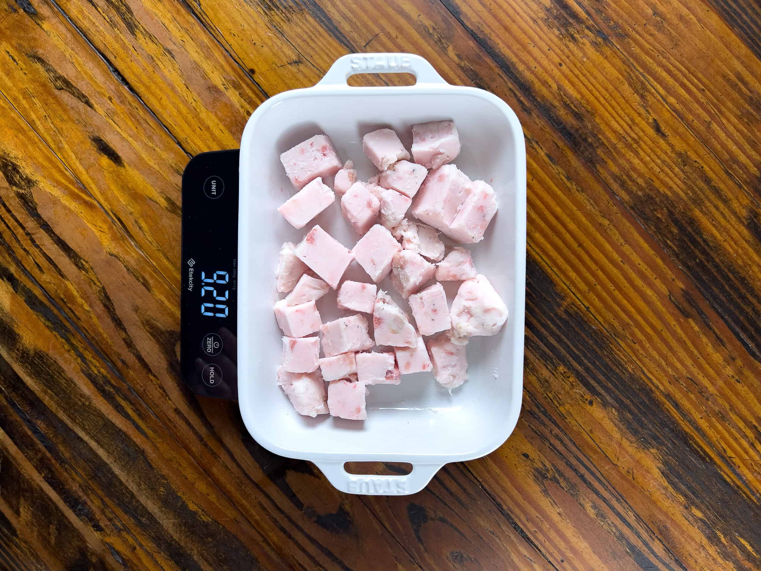 Pork fat resting on a scale.