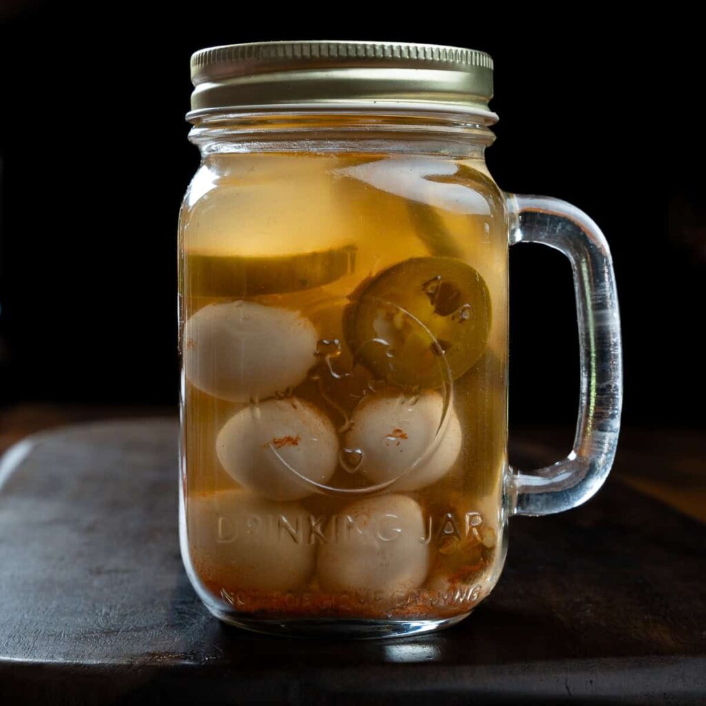 Cajun pickled quail eggs in a mason jar.