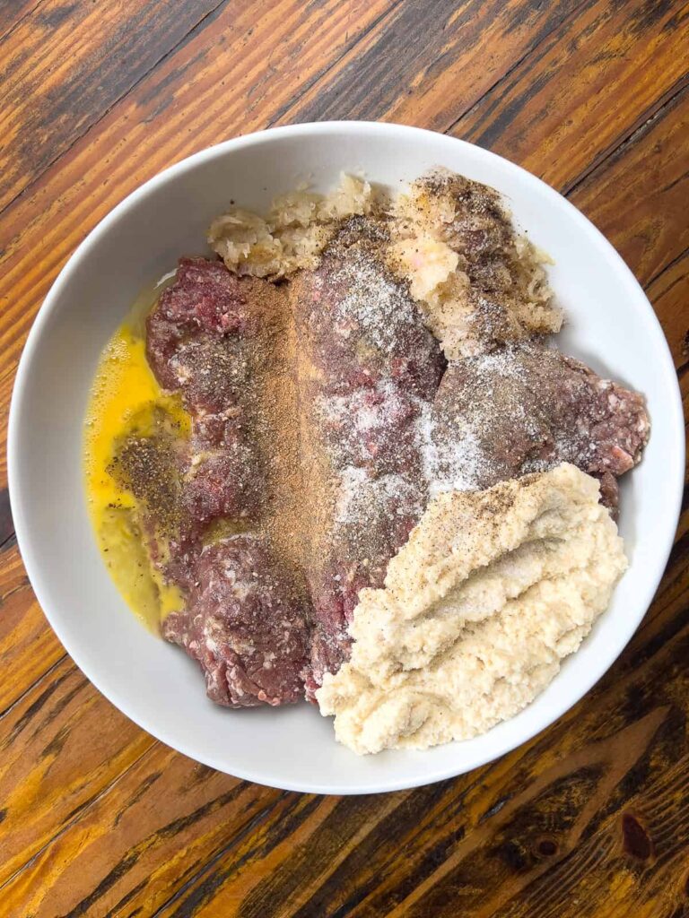 Venison meatloaf ingredients in mixing bowl.