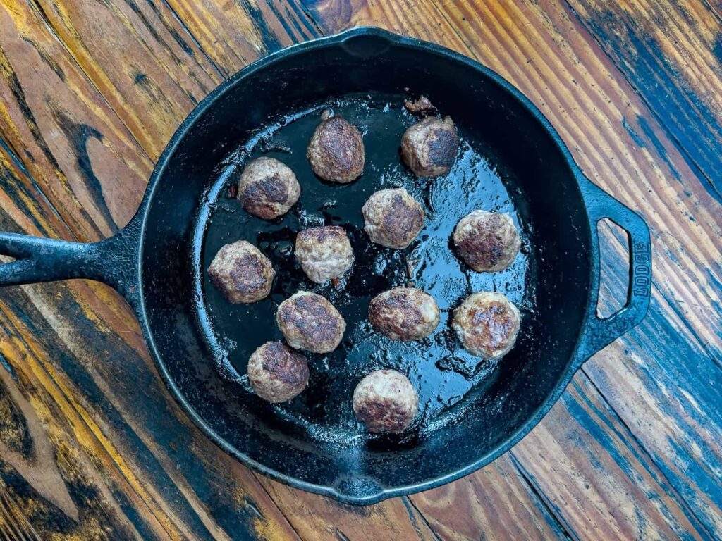 Meatballs in a cast-iron skillet.
