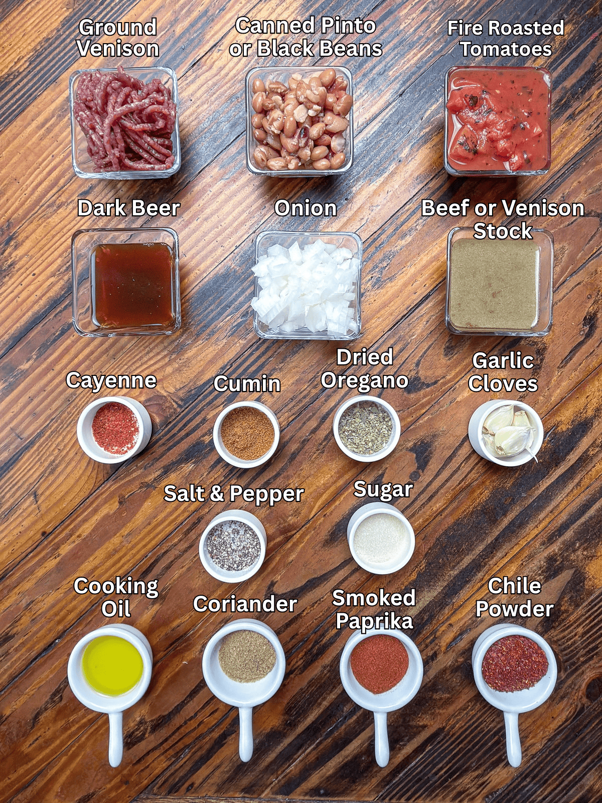 Ingredients for venison chili on a wooden table.