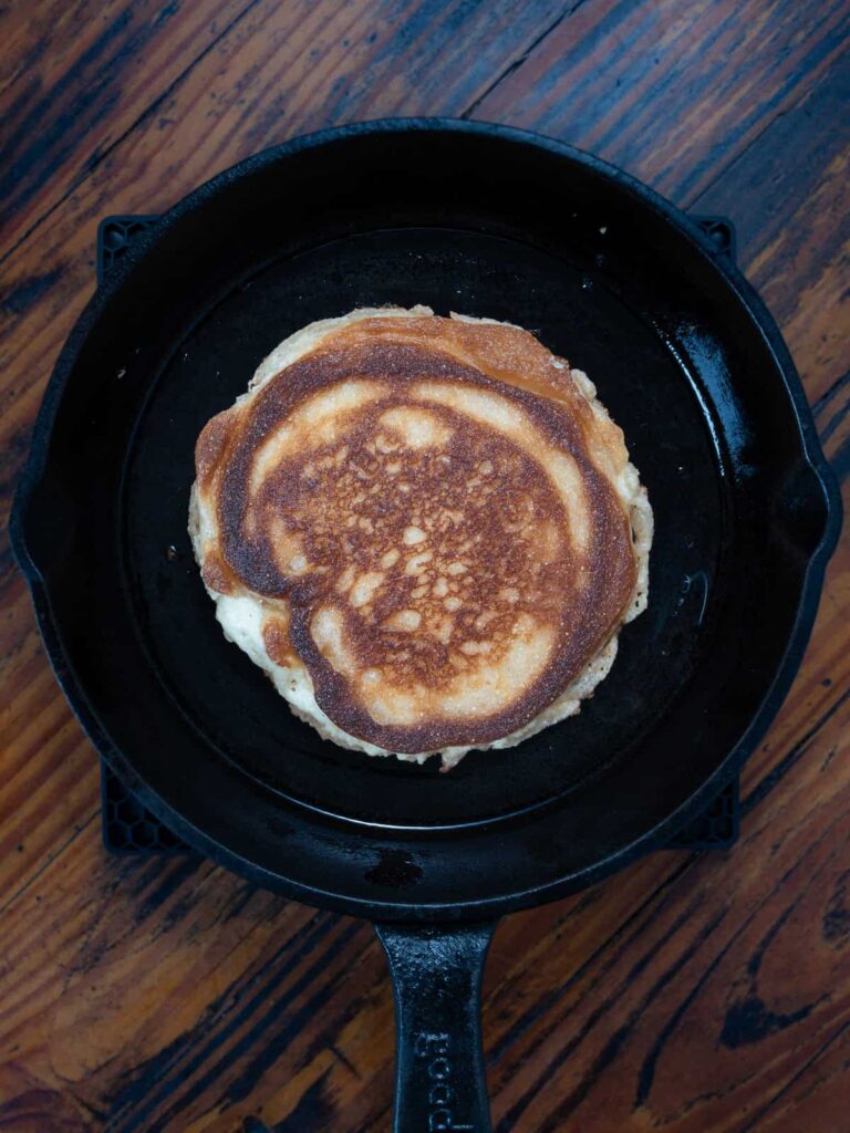 Crispy brown cornbread in a cast iron skillet.