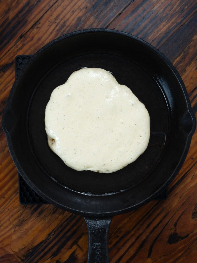 Cooking fried cornbread in cast iron.