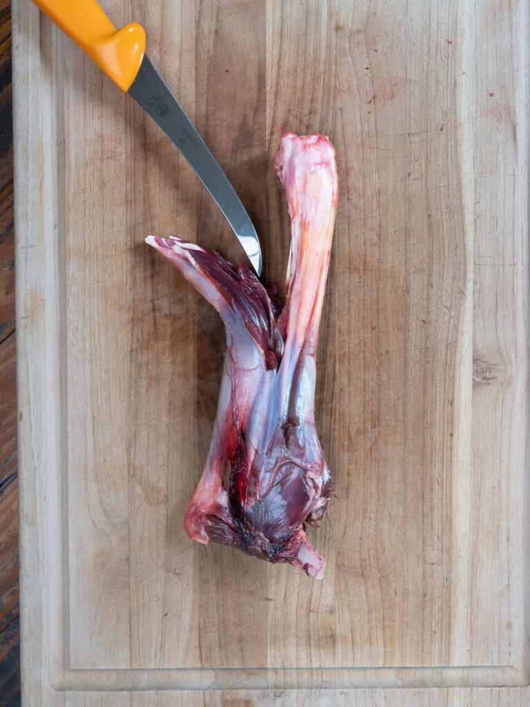 deboning the meat from the shank.