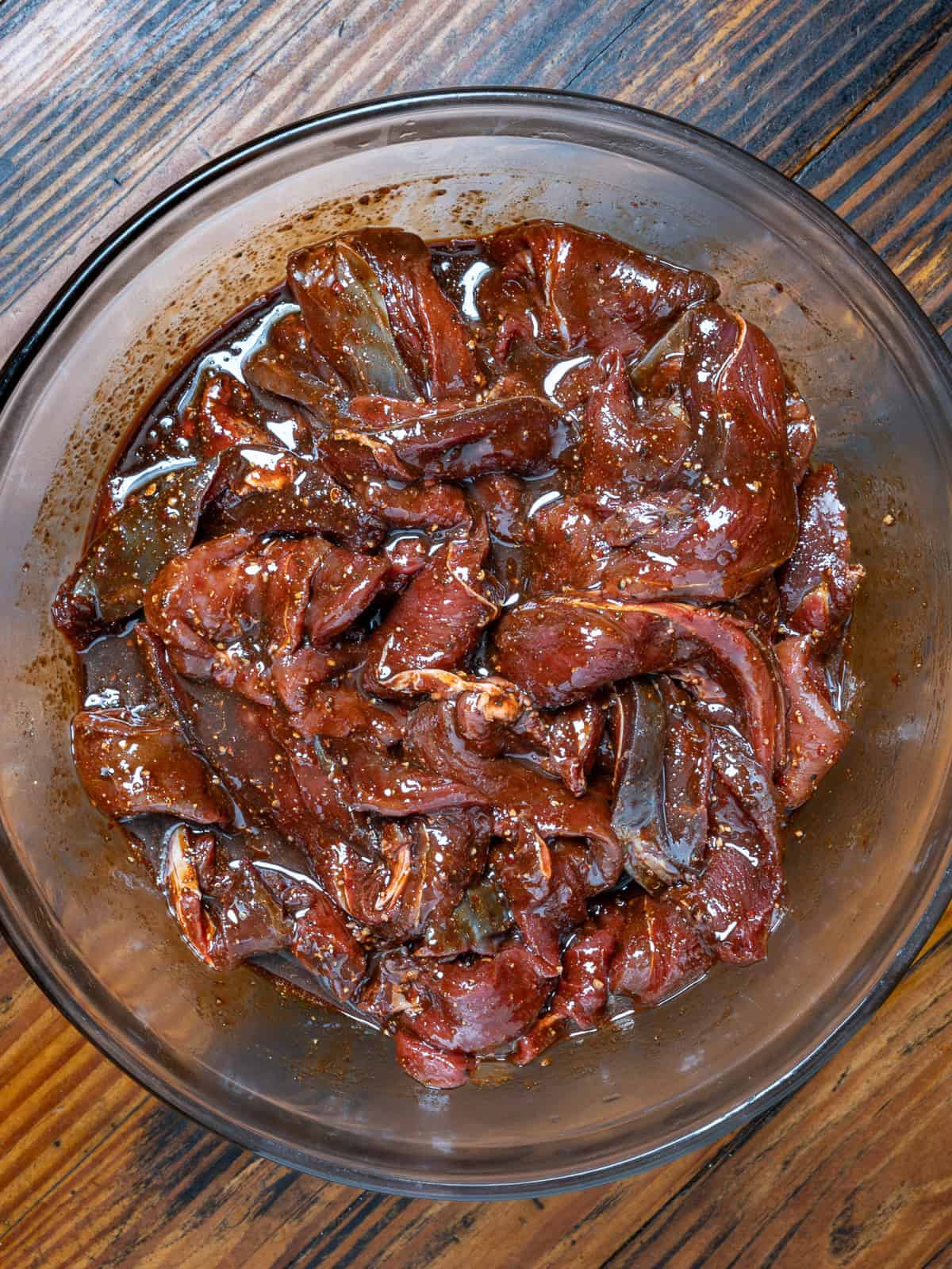 Venison marinating in a bowl for jerky.