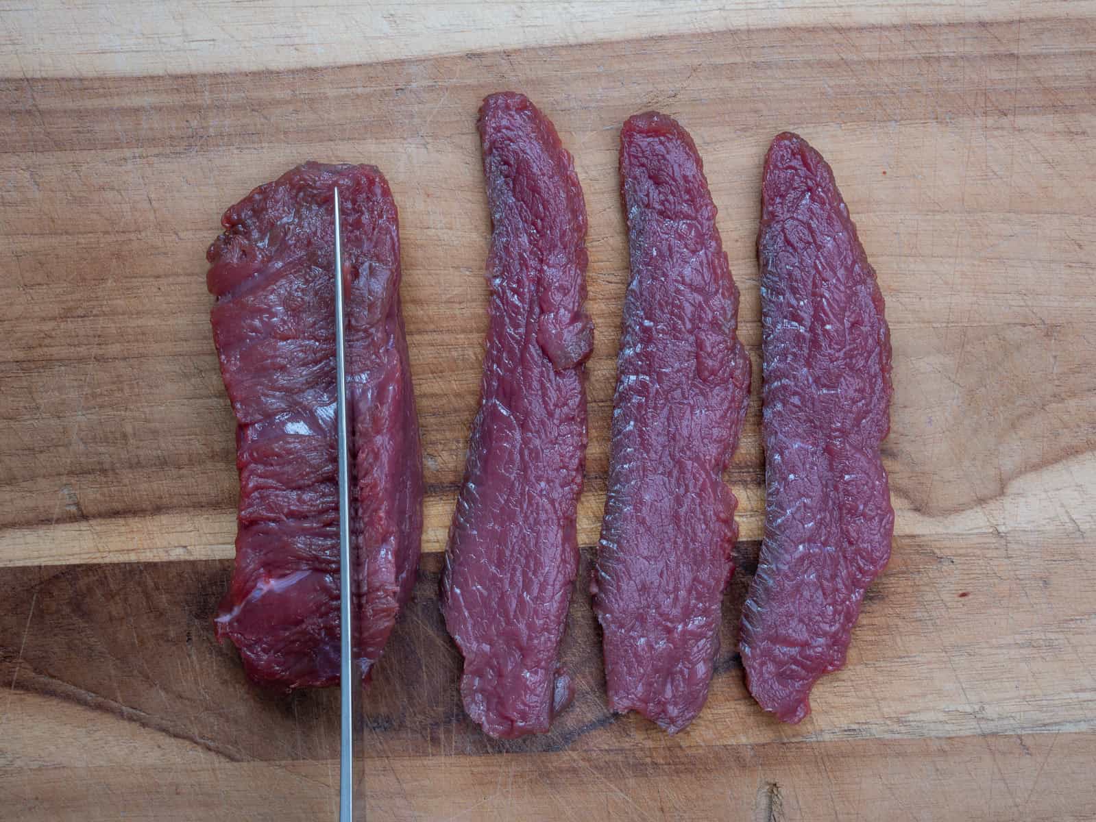 Cutting venison across the grain.
