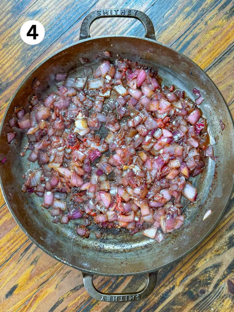 Sauteed onions, garlic and tomato paste in a cast iron pan.