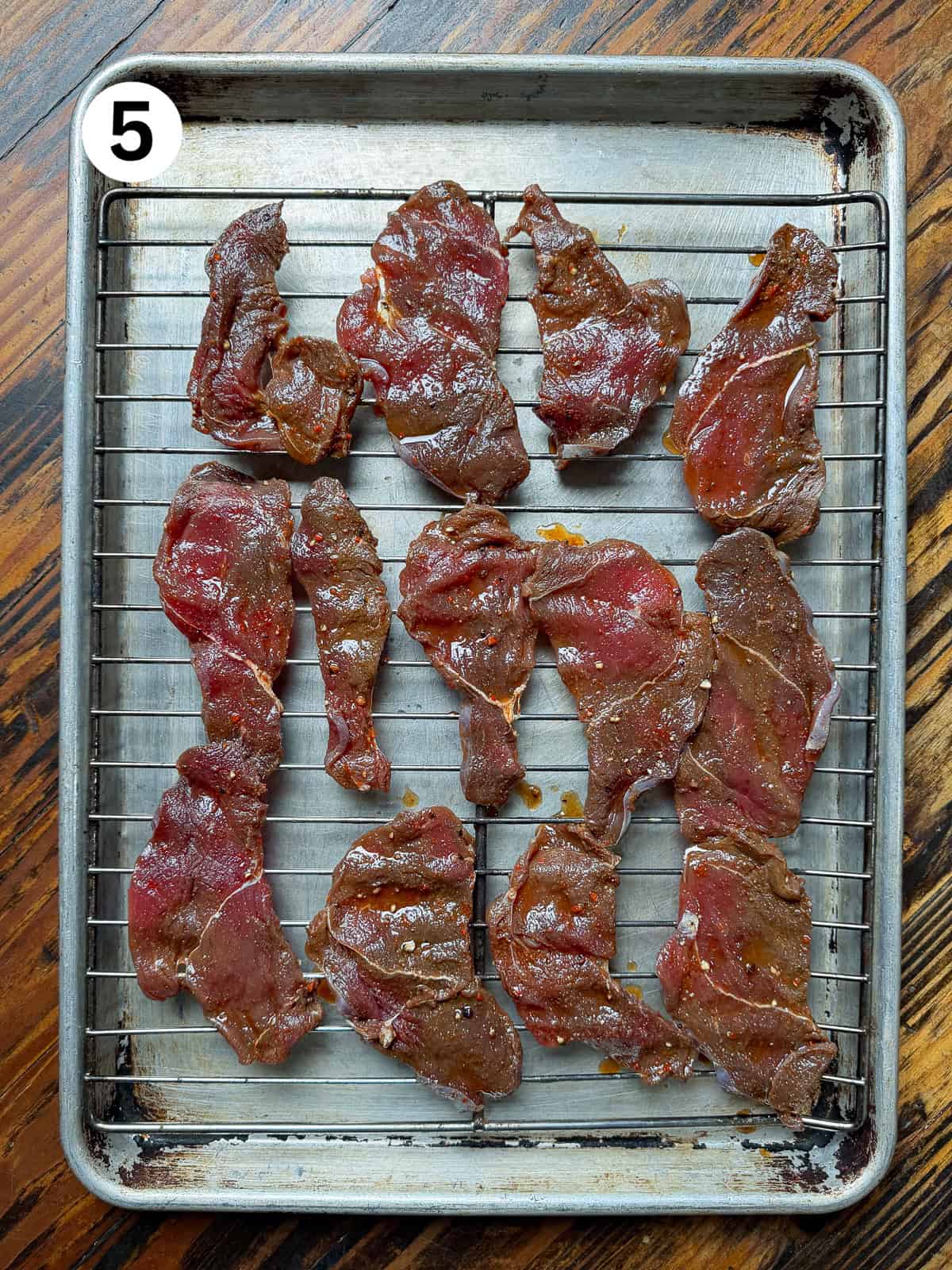 Venison jerky on a wire rack ready for smoking.