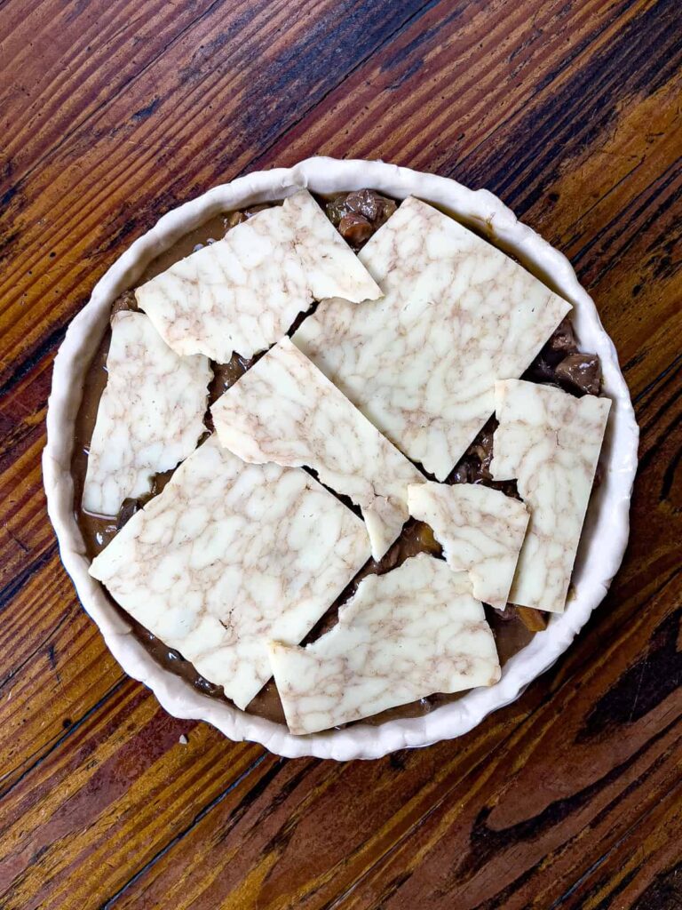 Venison Pie topped with cheese.