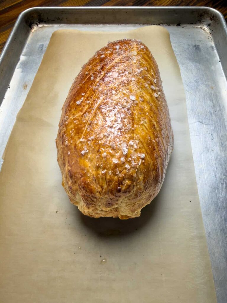 baked venison wellington on a baking pan.