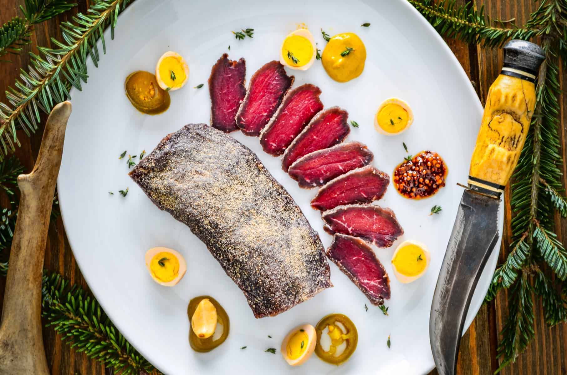 Cured venison loin on a holiday platter.