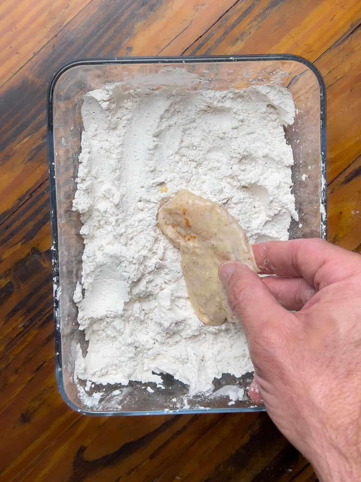 Coating catfish in the second breading.