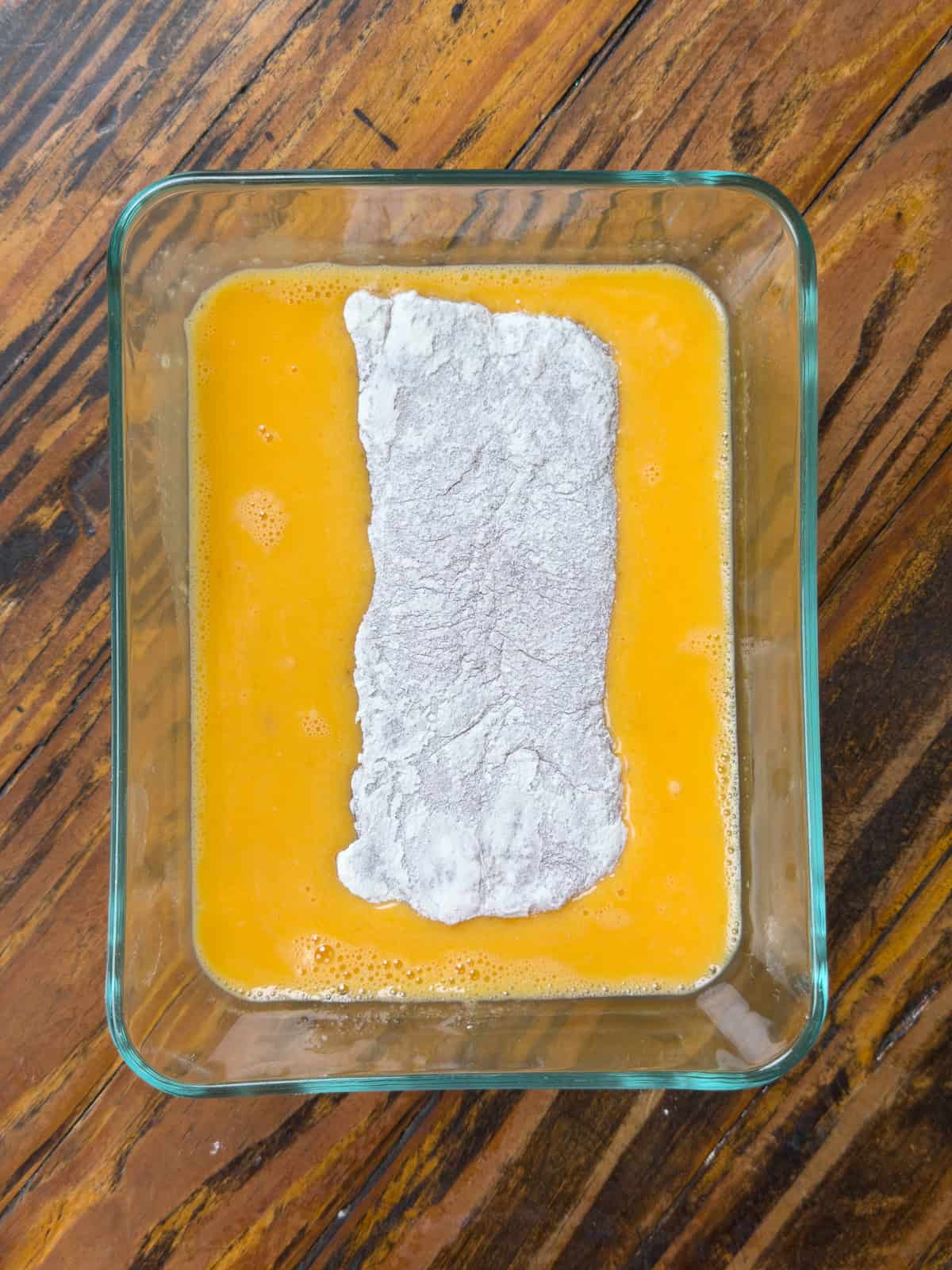 Pork loin dipped in egg wash.