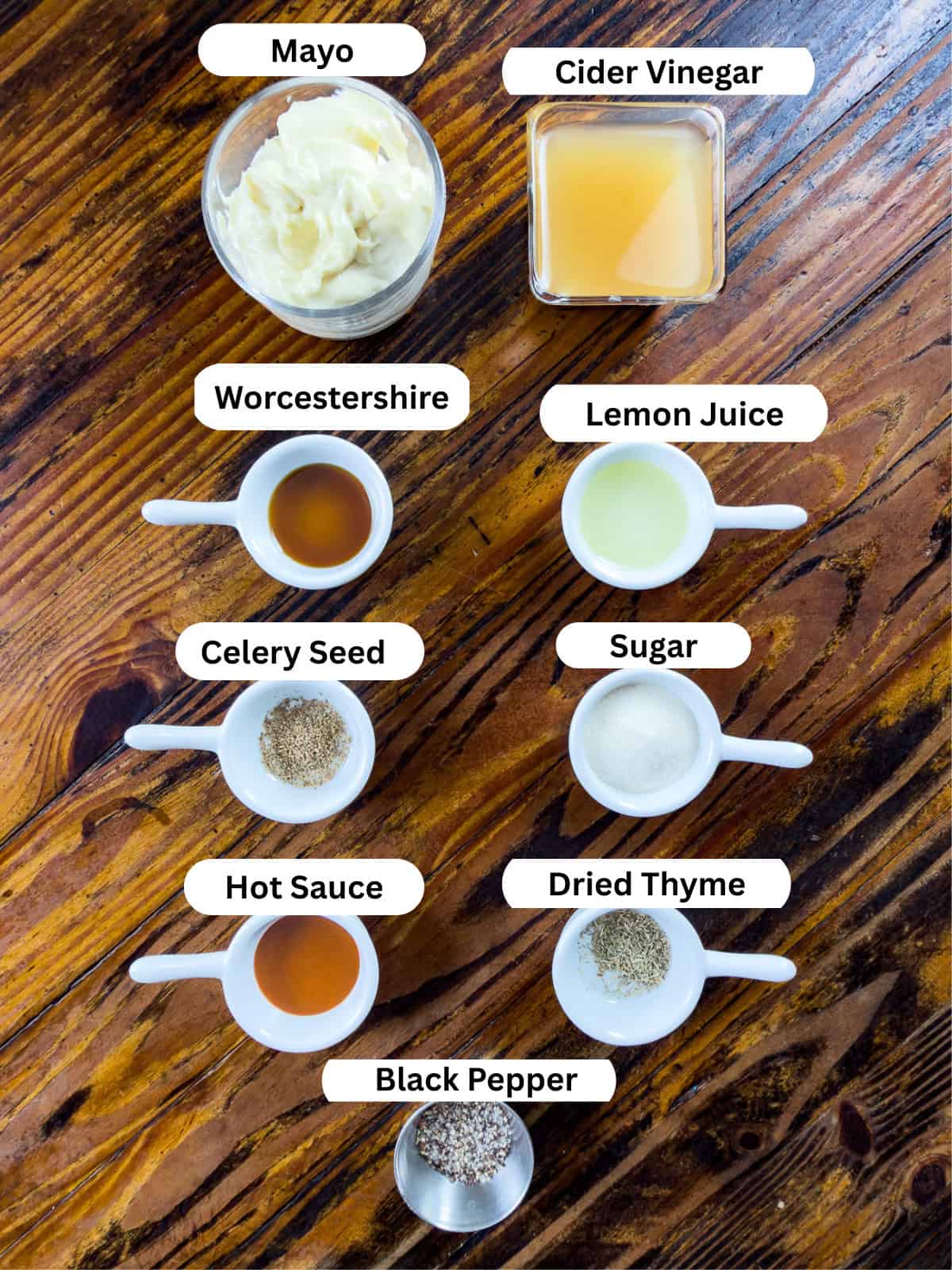 Ingredients for Alabama white sauce in dishes sitting on a table.