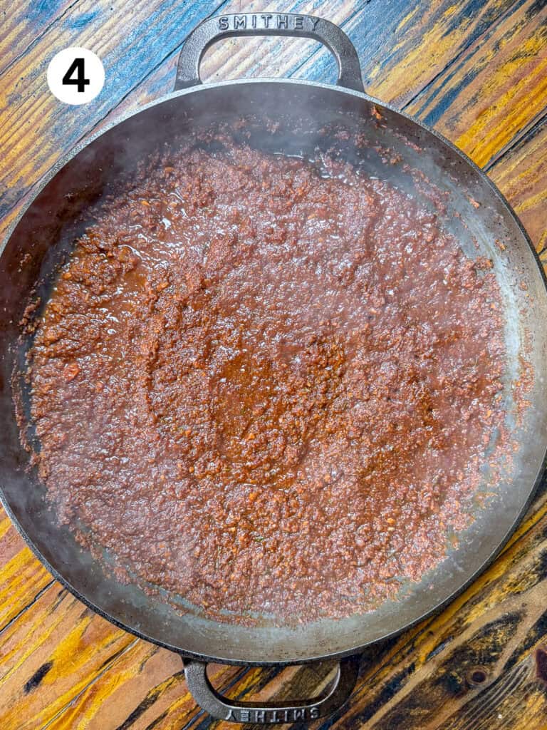 Carrots, onions, garlic, tomato paste and wine in a cast iron pan.