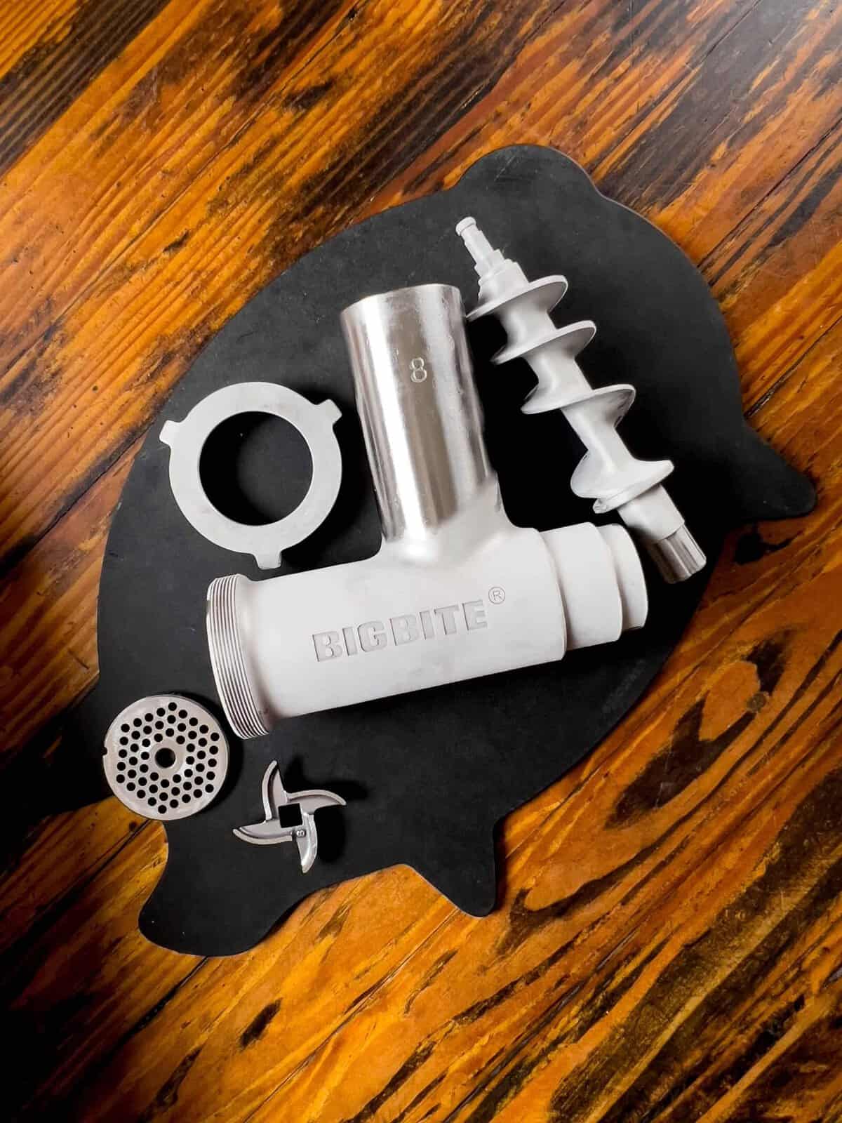 Chilled grinder parts resting on a cutting board.