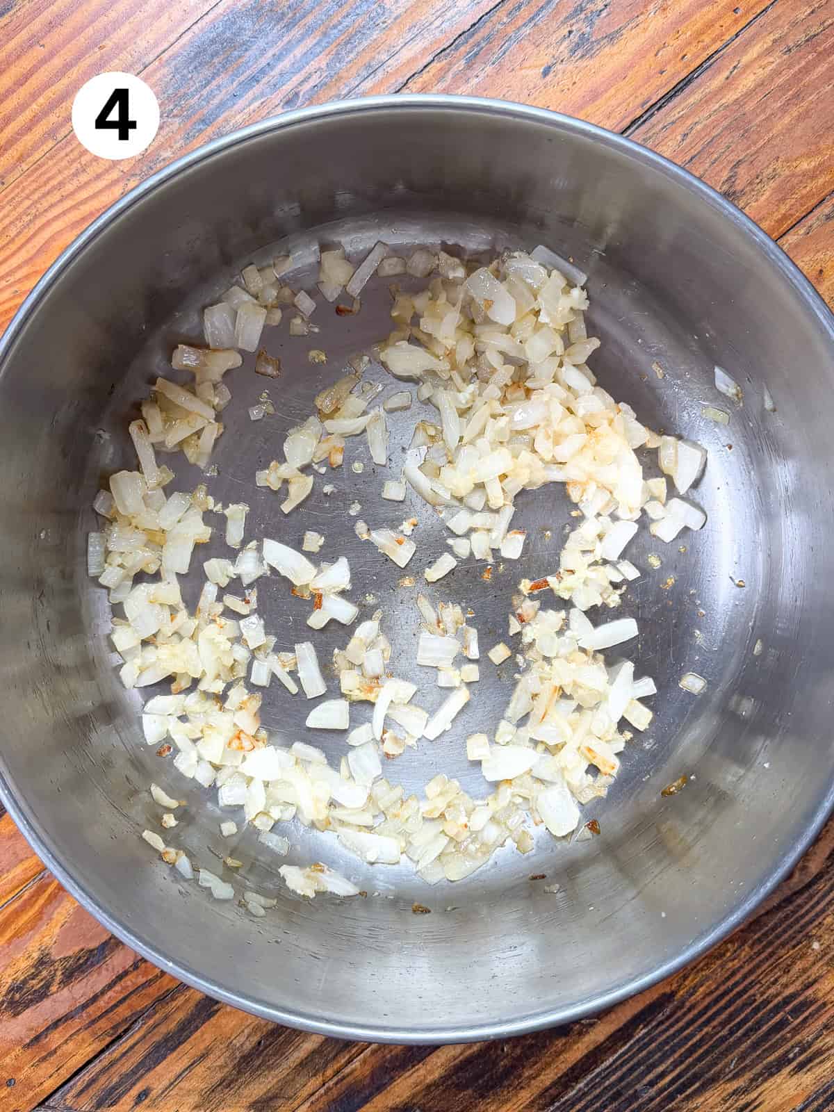 Sauteed onions and garlic in a stainless pot.