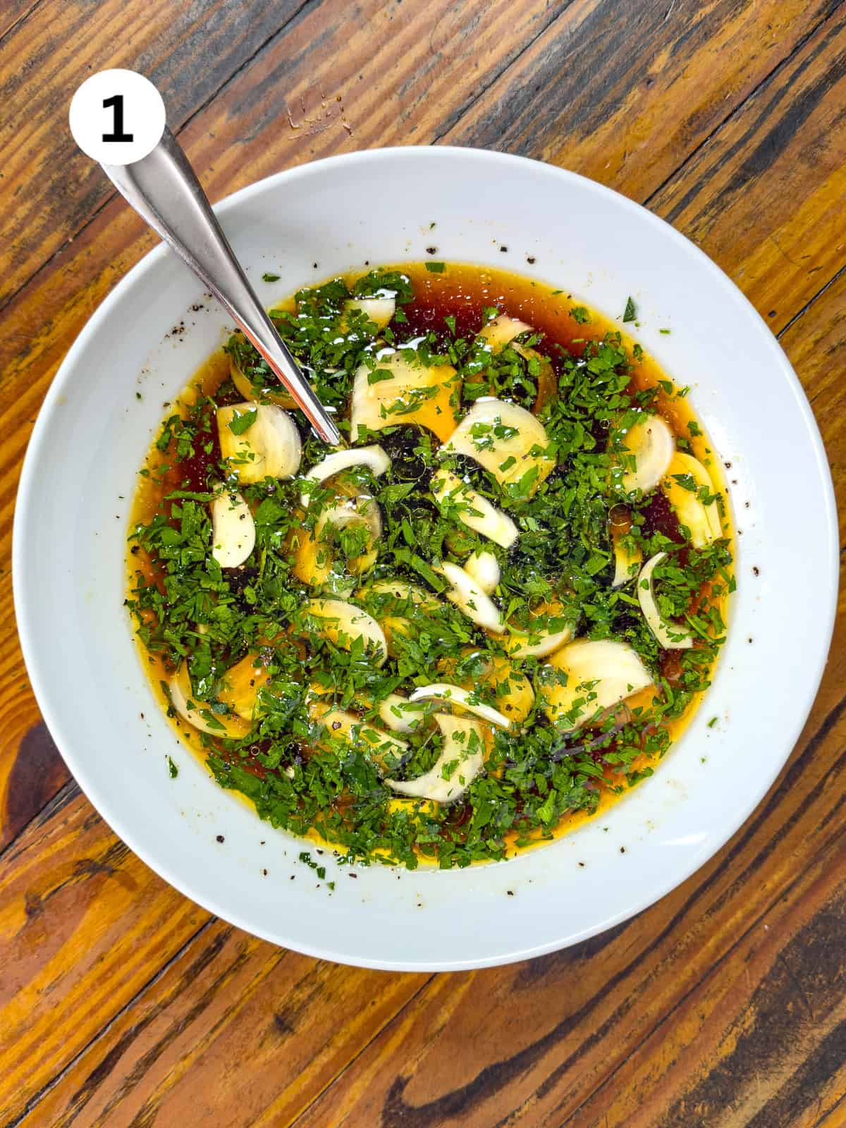 Venison Marinade in a white bowl on a wooden table.