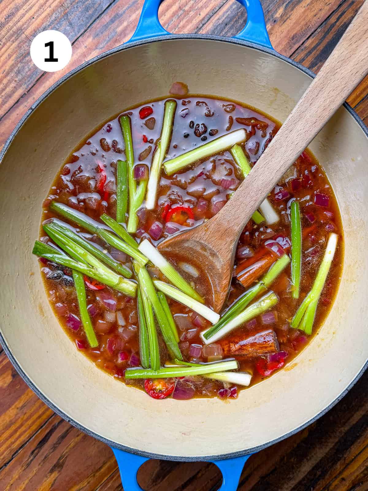 Cooking liquid for a venison roast in a pot.