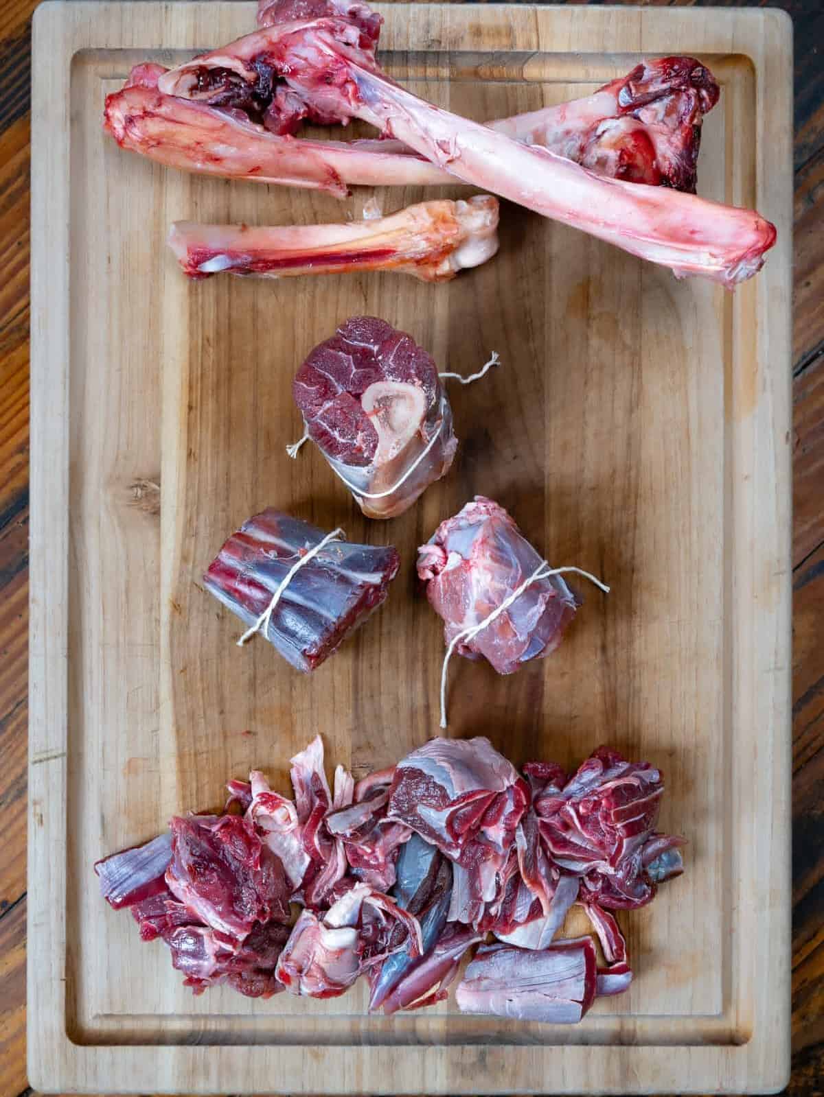 Venison shanks on a cutting board.